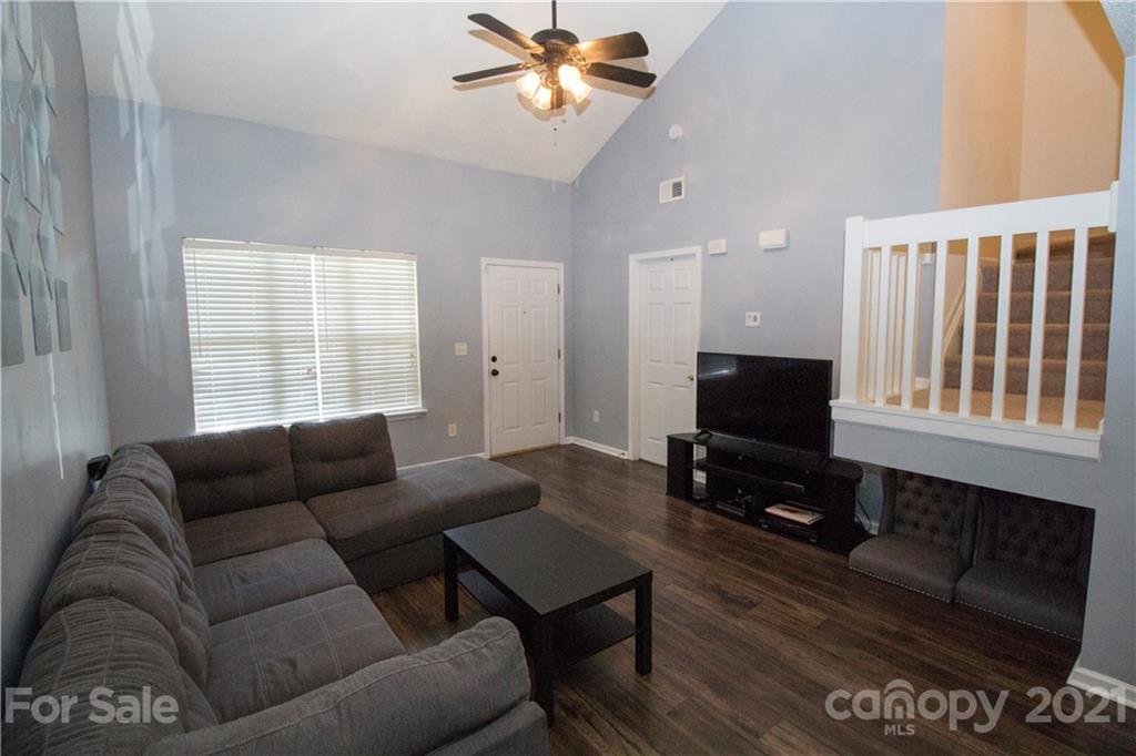 8360 Rudolph Road Charlotte, NC 28216 - Photo 5 of 20 a living room with furniture a flat screen tv and a window