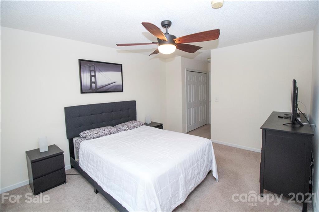 8360 Rudolph Road Charlotte, NC 28216 - Photo 8 of 20 a bedroom with a bed and a flat screen tv