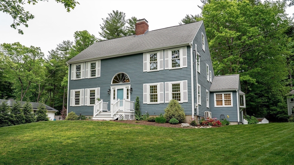 142 Baker Street Walpole, MA 02081 - Photo 6 of 42 a front view of a house with a yard