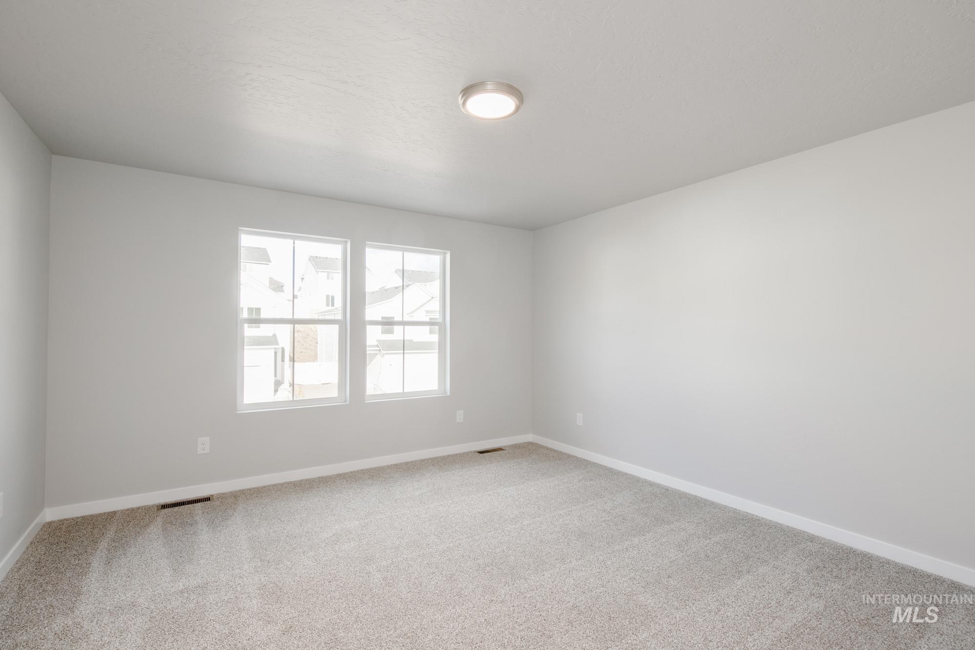 229 Moose Street Horseshoe Bend, ID 83629 - Photo 21 of 26 Spare room with baseboards and light carpet