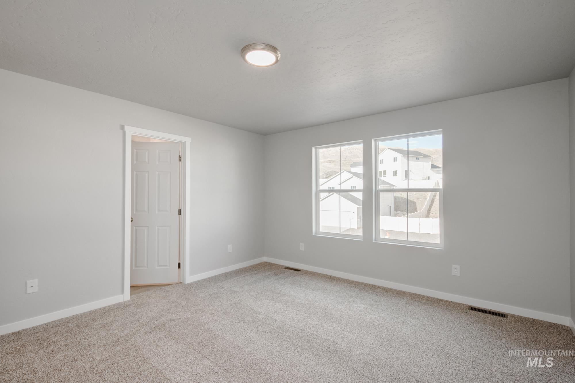 229 Moose Street Horseshoe Bend, ID 83629 - Photo 22 of 26 Empty room featuring light carpet and baseboards