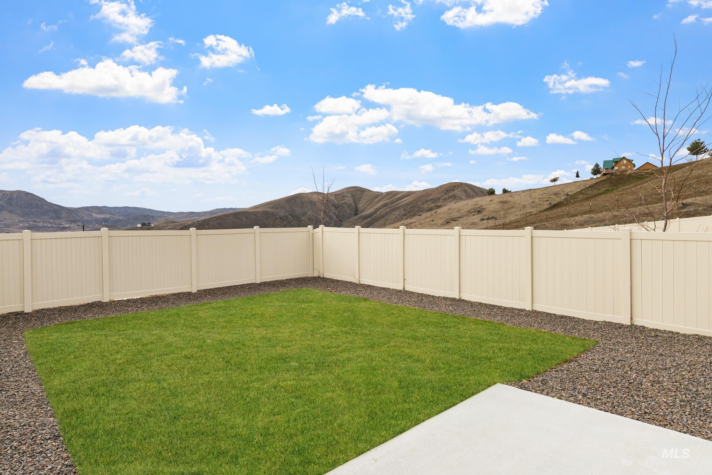 229 Moose Street Horseshoe Bend, ID 83629 - Photo 23 of 27 Fenced backyard featuring a mountain view and a patio