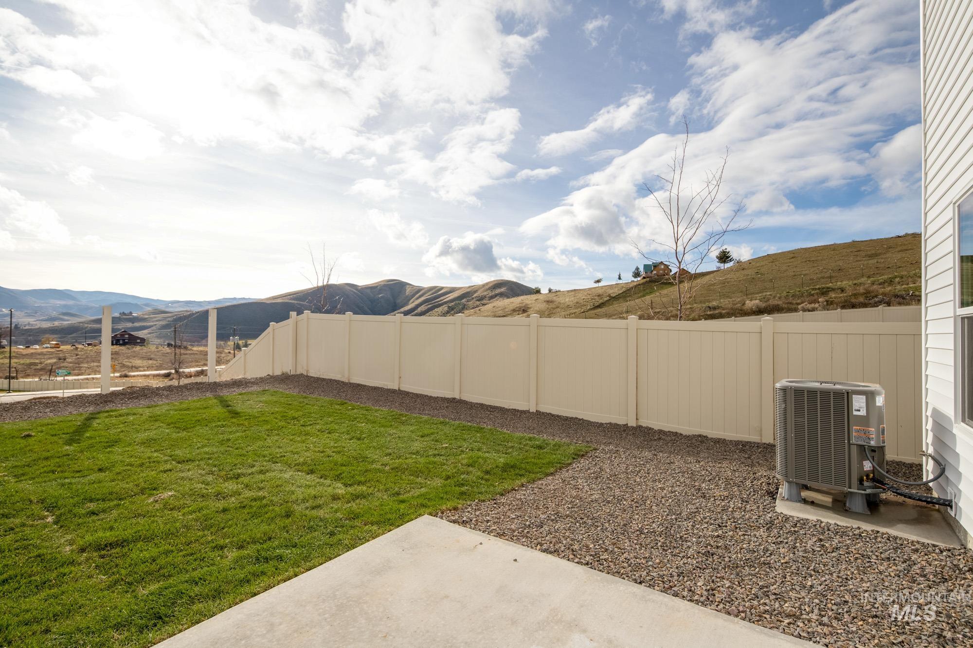 229 Moose Street Horseshoe Bend, ID 83629 - Photo 23 of 26 Fenced backyard with a mountain view and a patio