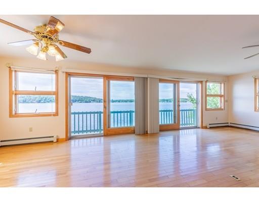 82 Lake Attitash Road Amesbury, MA 01913 - Photo 13 of 42 a view of an empty room with wooden floor and a window