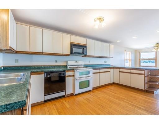82 Lake Attitash Road Amesbury, MA 01913 - Photo 19 of 42 a kitchen with stainless steel appliances granite countertop a stove a sink and a microwave