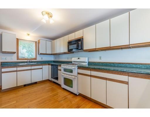 82 Lake Attitash Road Amesbury, MA 01913 - Photo 20 of 42 a kitchen with stainless steel appliances granite countertop a stove a sink and a microwave