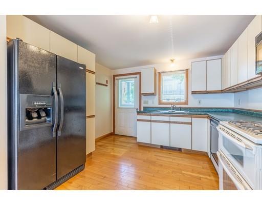 82 Lake Attitash Road Amesbury, MA 01913 - Photo 21 of 42 a kitchen with stainless steel appliances granite countertop a refrigerator and a stove