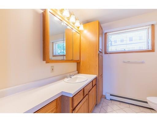 82 Lake Attitash Road Amesbury, MA 01913 - Photo 22 of 42 a bathroom with a sink a mirror and a shower
