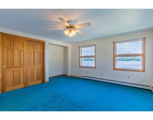82 Lake Attitash Road Amesbury, MA 01913 - Photo 24 of 42 a view of an empty room with window and wooden floor