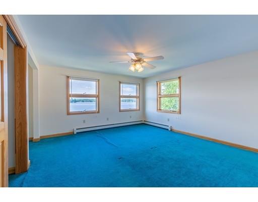 82 Lake Attitash Road Amesbury, MA 01913 - Photo 25 of 42 a view of an empty room with window and wooden floor