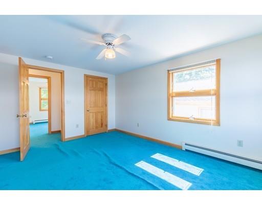 82 Lake Attitash Road Amesbury, MA 01913 - Photo 26 of 42 a view of empty room with wooden floor and fan