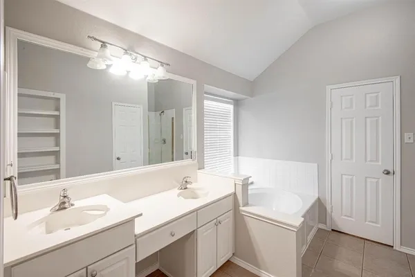 a bathroom with a double vanity sink mirror and
