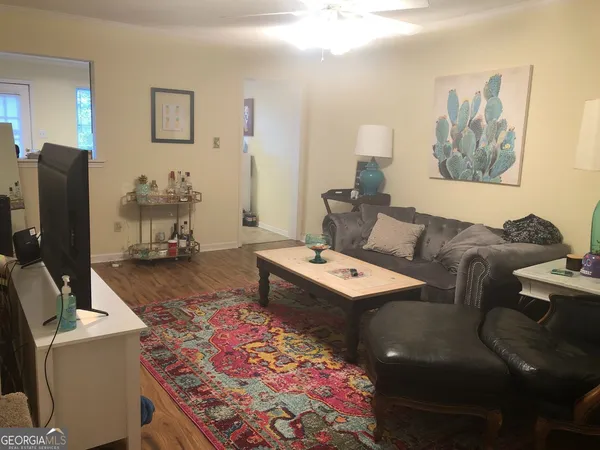 a living room with furniture and a flat screen tv