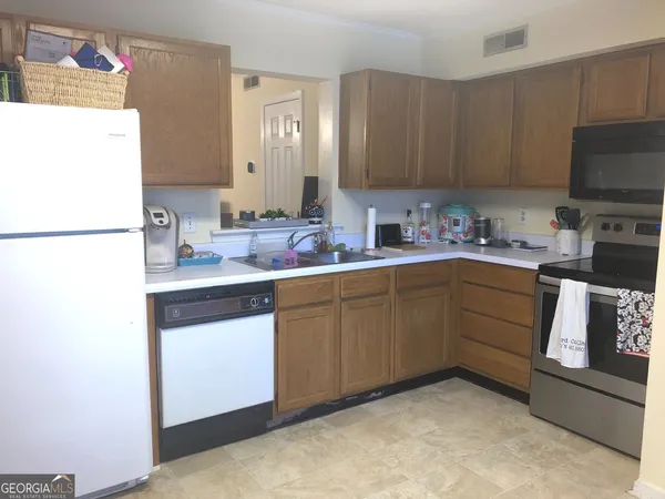 a kitchen with a sink a stove and refrigerator