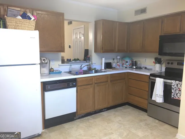 a kitchen with a sink a stove and refrigerator