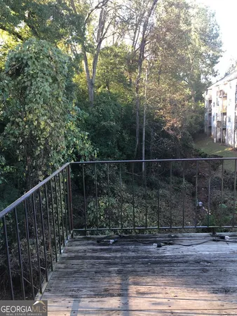 a view of a fence and trees