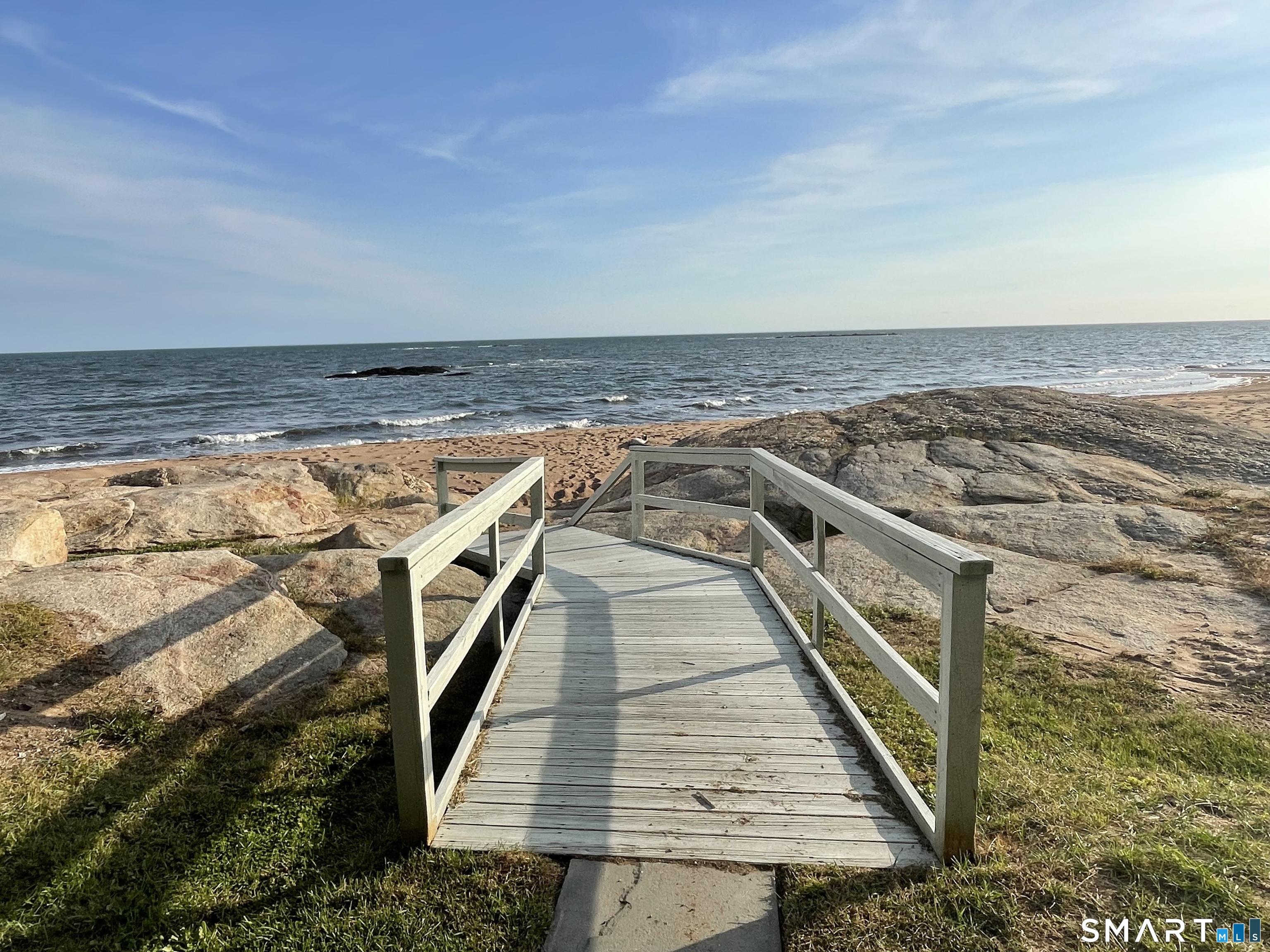1 Mansfield Grove Road, Unit 103 East Haven, CT 06512 - Photo 37 of 39 a view of a roof deck with wooden floor and fence