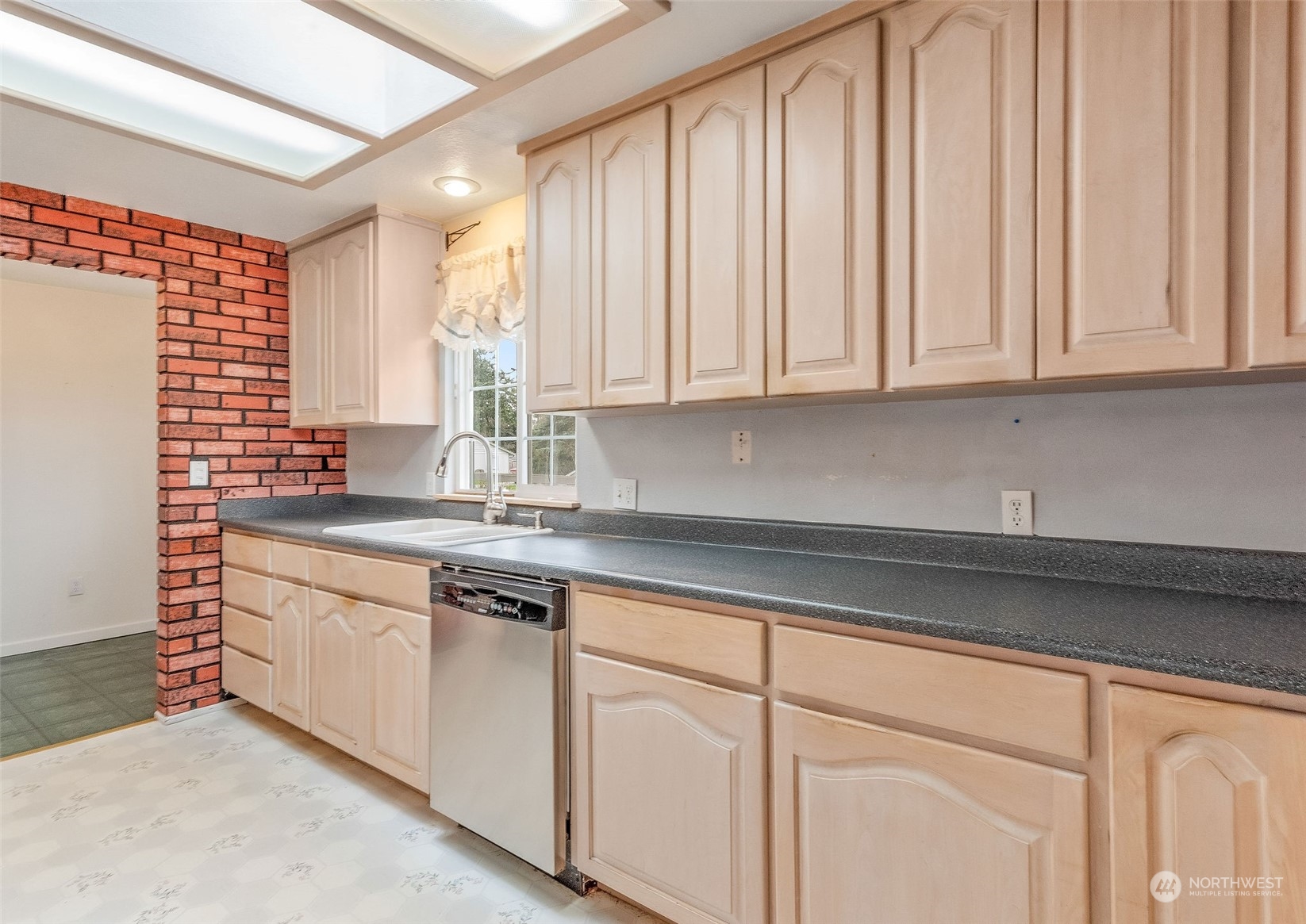 720 Memory Lane Port Townsend, WA 98368 - Photo 11 of 33 a kitchen with granite countertop white cabinets and sink