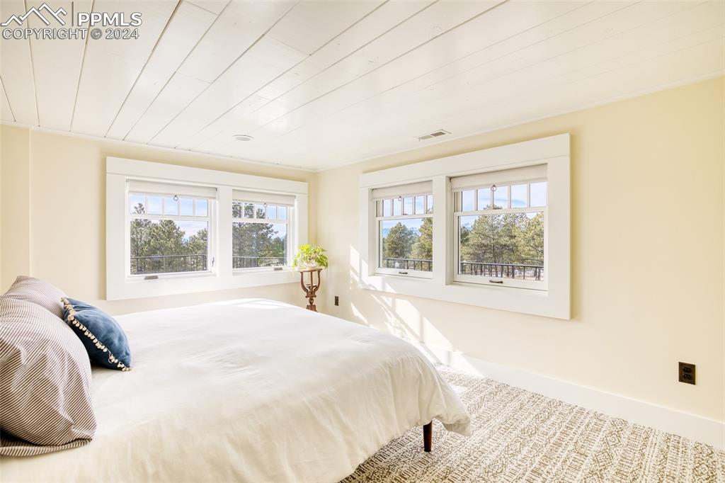 11508 Shaugnessy Road Colorado Springs, CO 80908 - Photo 16 of 49 a large bed sitting in a bedroom next to a window