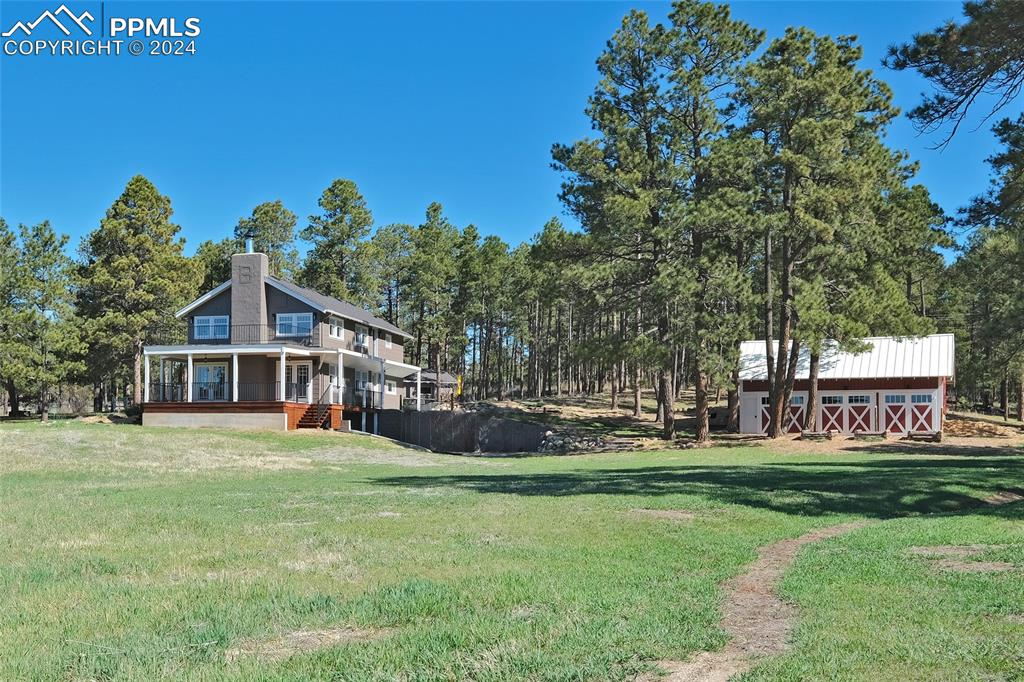 11508 Shaugnessy Road Colorado Springs, CO 80908 - Photo 42 of 49 a house with garden in front of it