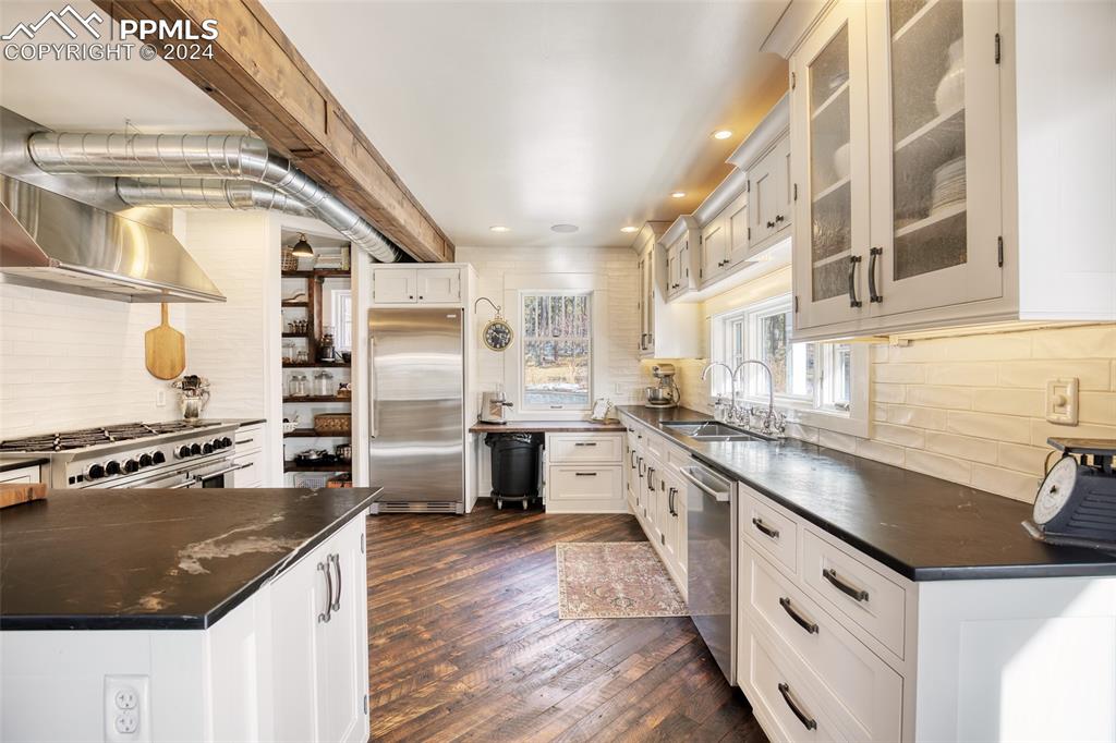 11508 Shaugnessy Road Colorado Springs, CO 80908 - Photo 46 of 49 a kitchen with stainless steel appliances granite countertop a stove and a sink