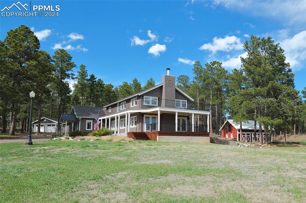 11508 Shaugnessy Road Colorado Springs, CO 80908 - Photo 47 of 49 a front view of a house with a garden and trees