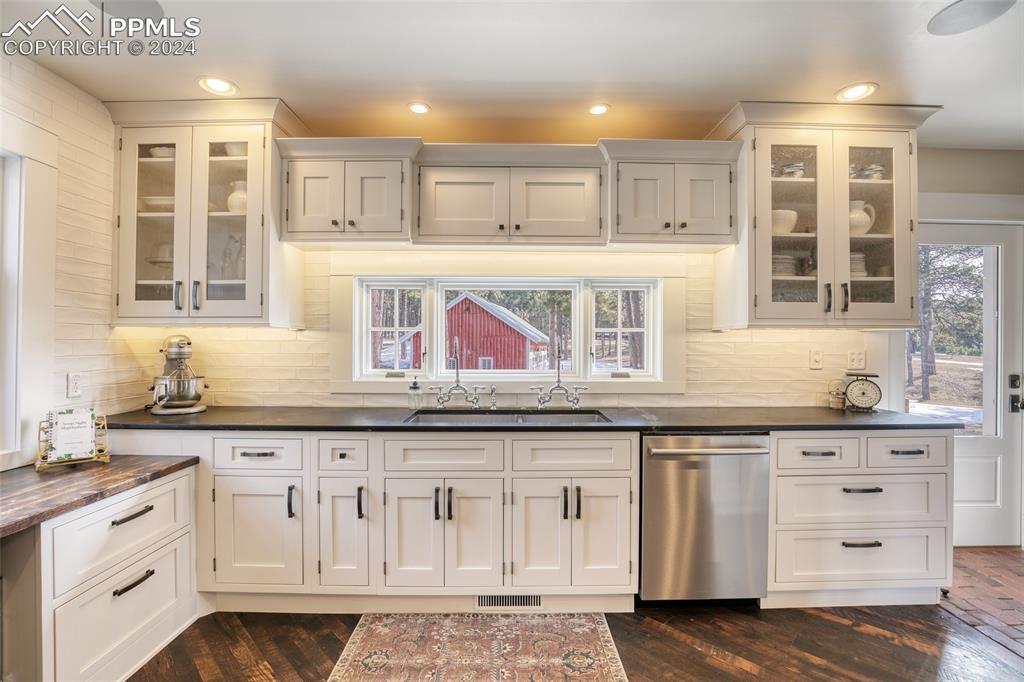 11508 Shaugnessy Road Colorado Springs, CO 80908 - Photo 6 of 49 a kitchen with granite countertop a sink and cabinets