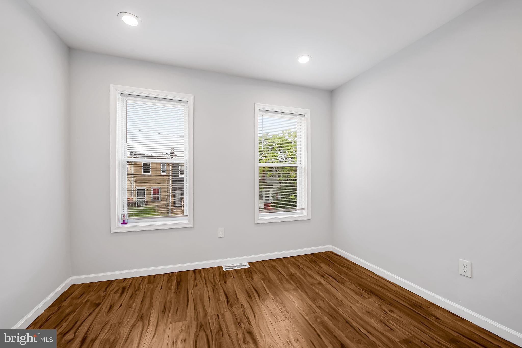 512 North Port Street Baltimore, MD 21205 - Photo 13 of 23 an empty room with wooden floor and windows