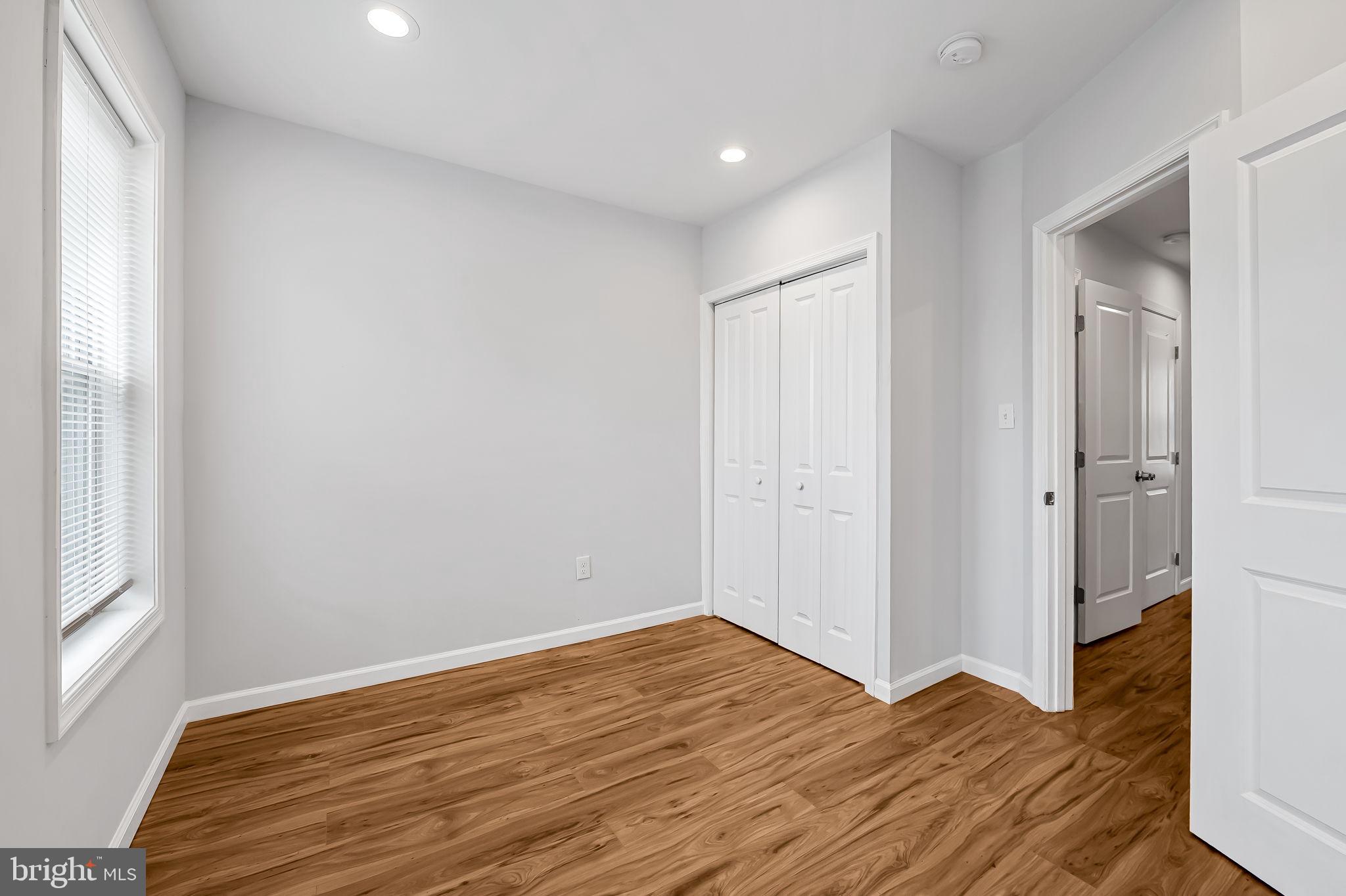 512 North Port Street Baltimore, MD 21205 - Photo 14 of 23 a view of empty room with wooden floor and fan