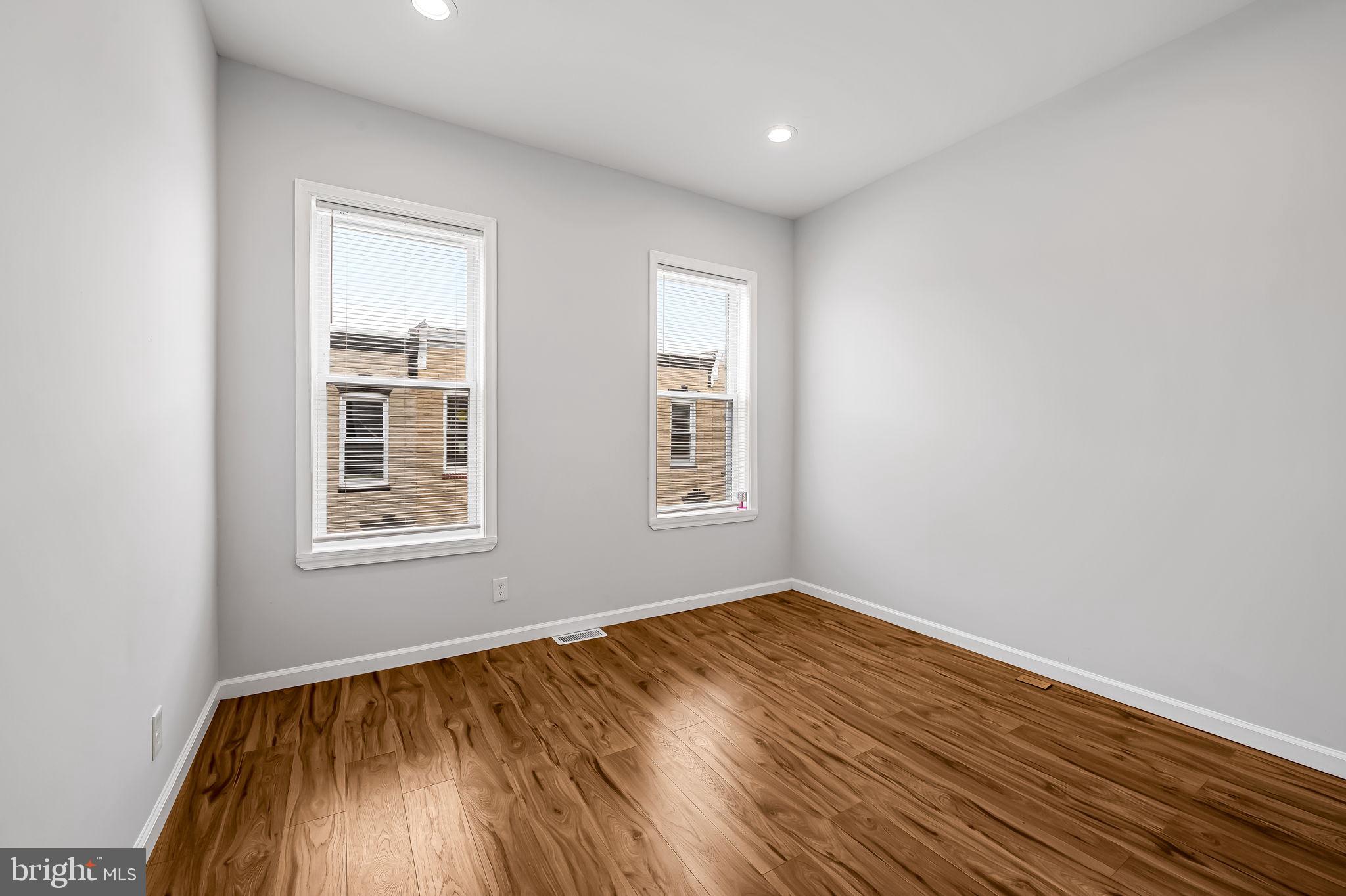 512 North Port Street Baltimore, MD 21205 - Photo 15 of 23 an empty room with wooden floor and windows