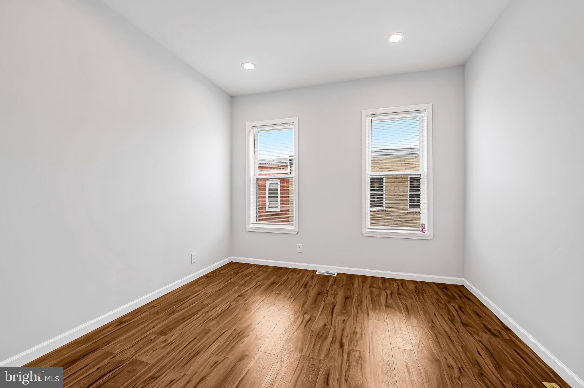 512 North Port Street Baltimore, MD 21205 - Photo 16 of 23 an empty room with wooden floor and windows