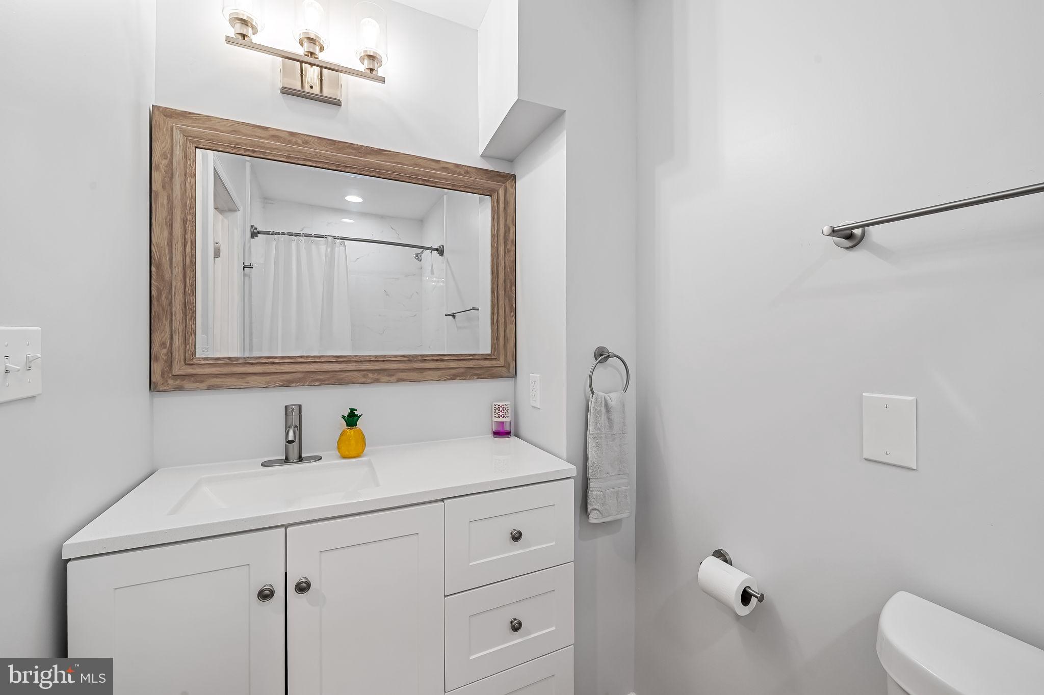 512 North Port Street Baltimore, MD 21205 - Photo 18 of 23 a bathroom with a sink vanity and mirror
