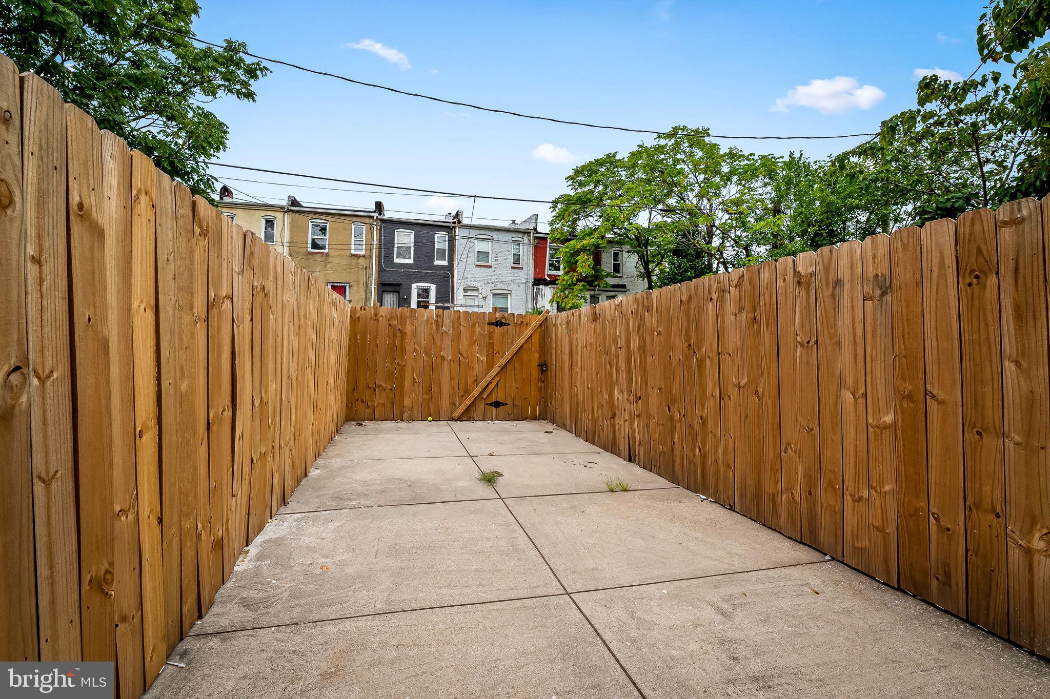 512 North Port Street Baltimore, MD 21205 - Photo 21 of 23 a view of a pathway gate with wooden fence