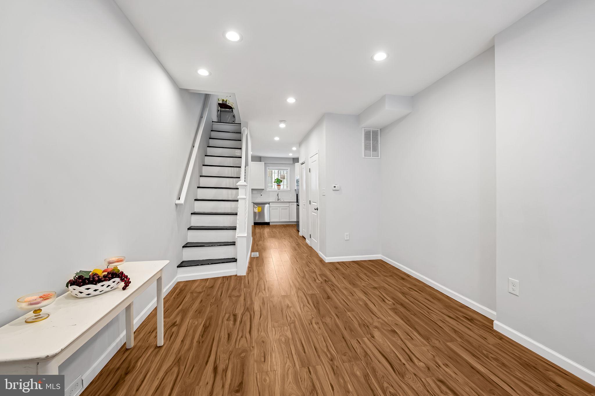 512 North Port Street Baltimore, MD 21205 - Photo 5 of 23 a view of entryway with stairs and wooden floor