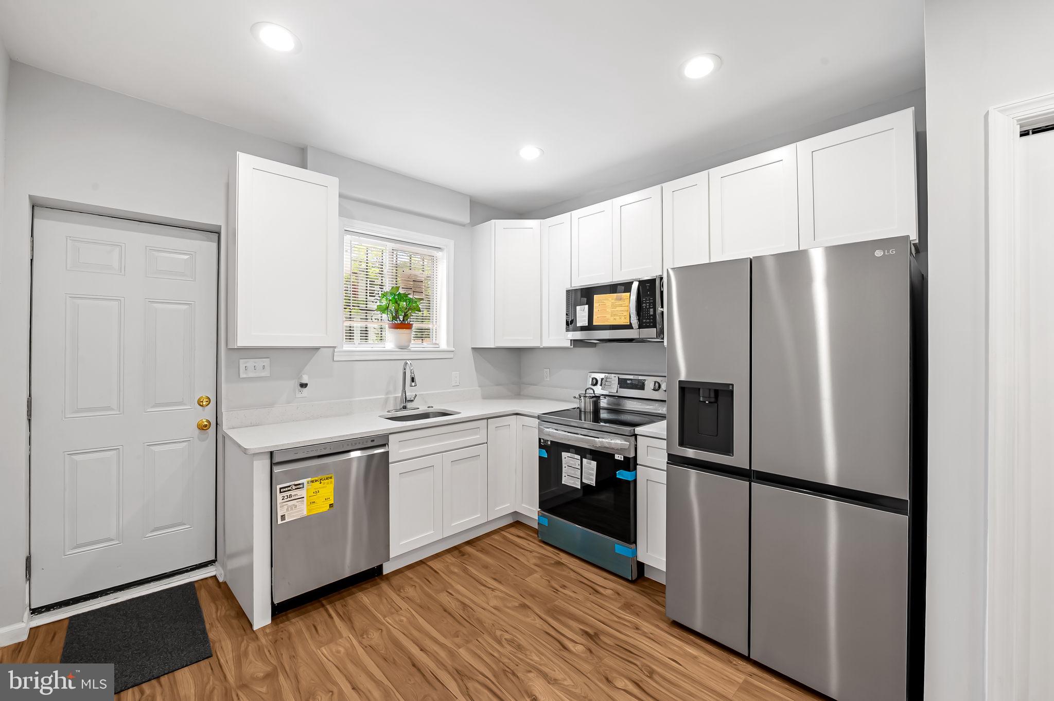 512 North Port Street Baltimore, MD 21205 - Photo 6 of 23 a kitchen with stainless steel appliances a refrigerator stove microwave and sink