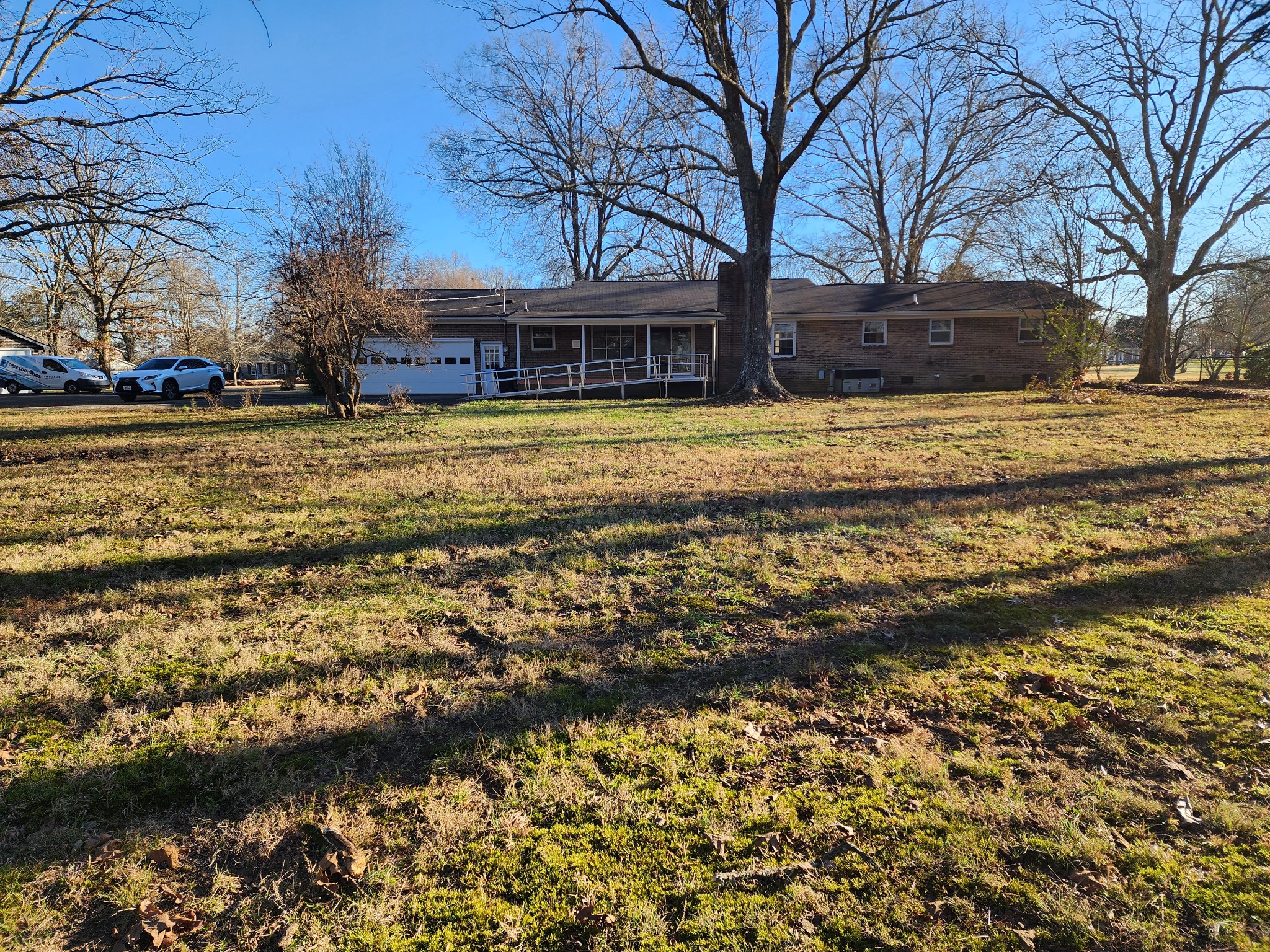 303 12 Oaks Road Tullahoma, TN 37388 - Photo 38 of 39 a front view of house with small garden and trees