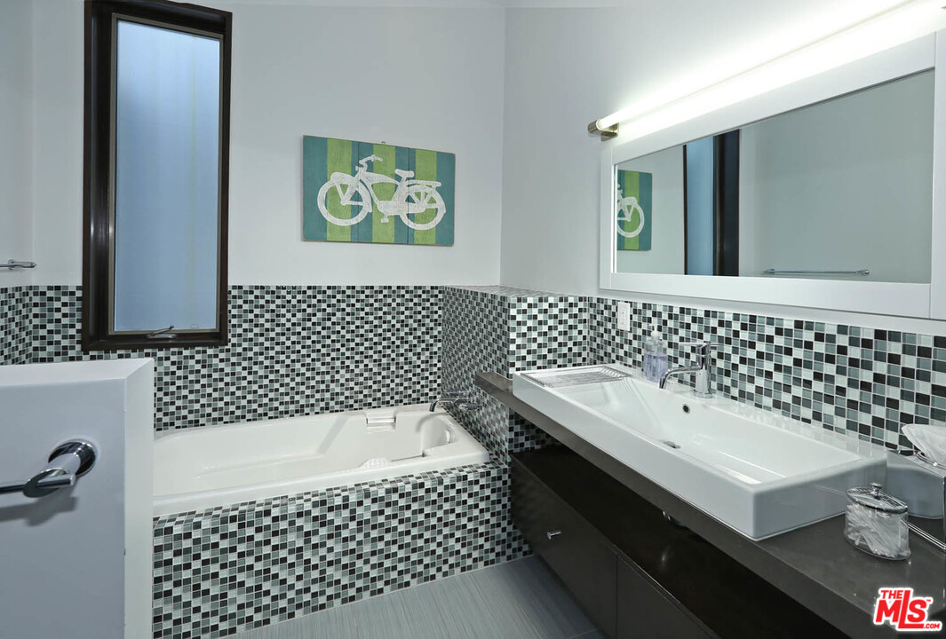 8532 Ridpath Drive Los Angeles, CA 90046 - Photo 15 of 52 a bathroom with a sink a toilet and shower