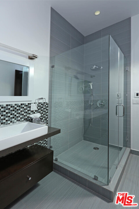 8532 Ridpath Drive Los Angeles, CA 90046 - Photo 16 of 52 a bathroom with a bathtub and a shower