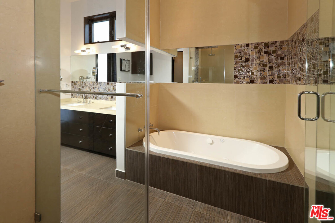 8532 Ridpath Drive Los Angeles, CA 90046 - Photo 19 of 52 a bathroom with a bathtub sink and mirror