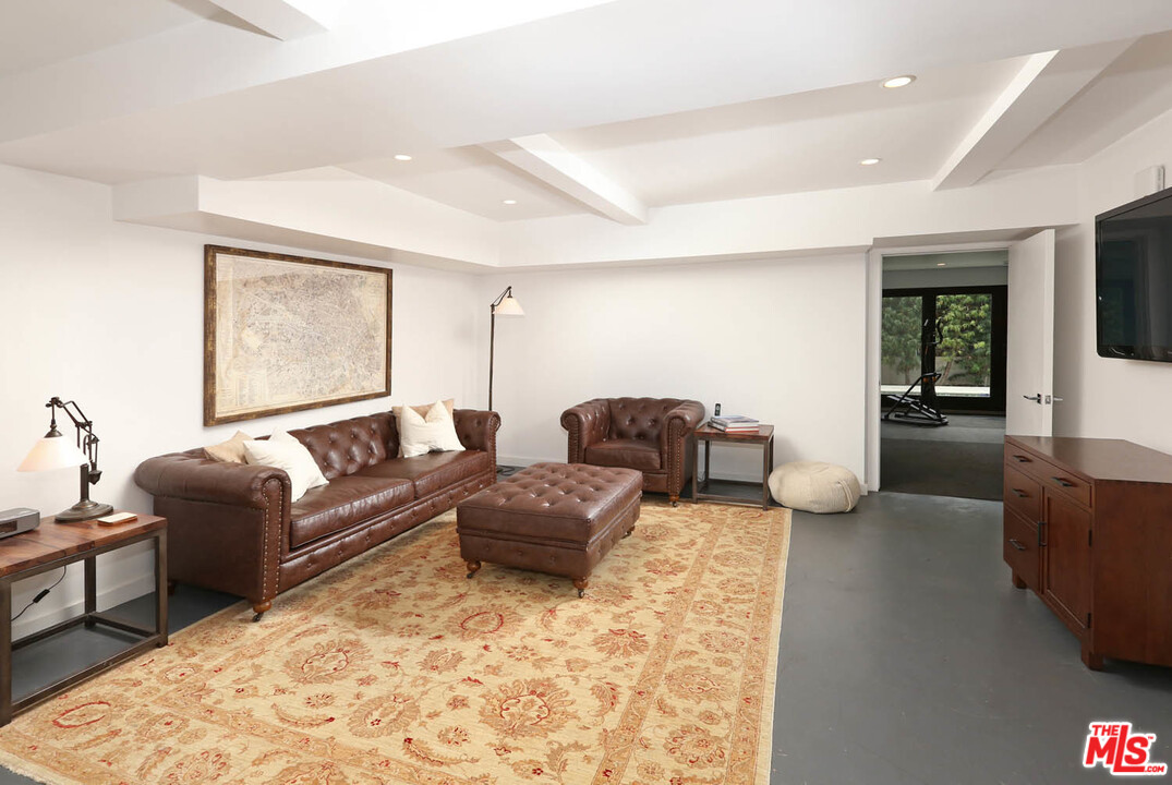 8532 Ridpath Drive Los Angeles, CA 90046 - Photo 32 of 52 a living room with furniture rug and wooden floor