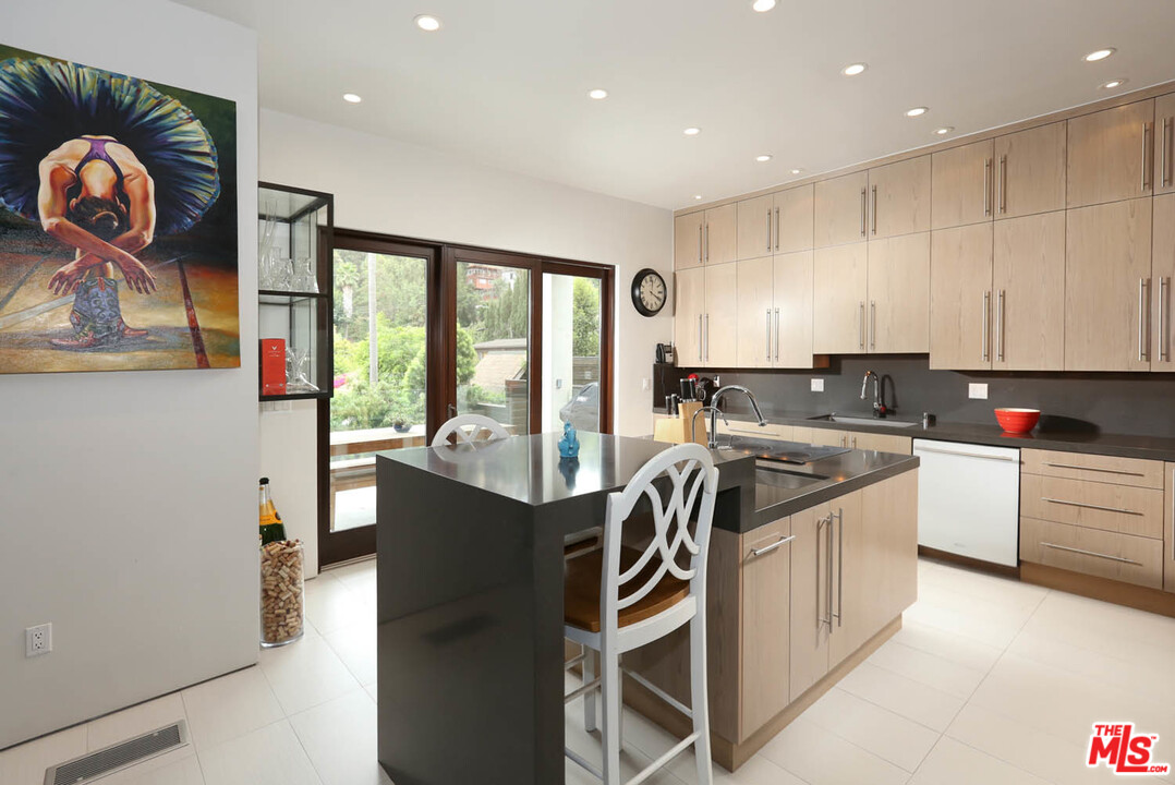 8532 Ridpath Drive Los Angeles, CA 90046 - Photo 9 of 52 a kitchen with stainless steel appliances granite countertop a stove a sink and a microwave