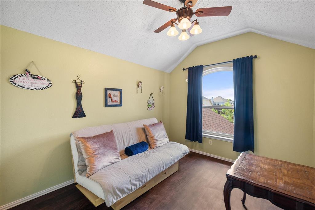 1305 Liverpool Lane Mansfield, TX 76063 - Photo 29 of 40 This room features a vaulted ceiling, a ceiling fan with lighting, and dark wood flooring