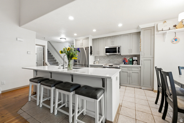 5196 Rodeo Circle Oakley, UT 84055 - Photo 16 of 57 Contemporary kitchen featuring a white countertop island, recessed lighting, and stainless steel appliances