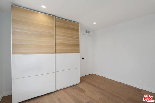 an empty room with wooden floor