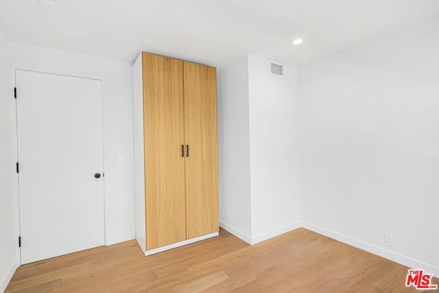 a view of hallway with wooden floor