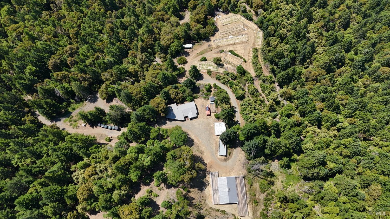 3761 East Blue Rock Road Garberville, CA 95542 - Photo 1 of 38 an aerial view of a house with a yard and large trees