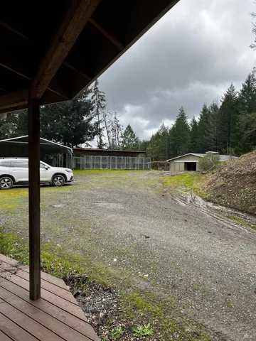 a view of backyard with large wooden deck