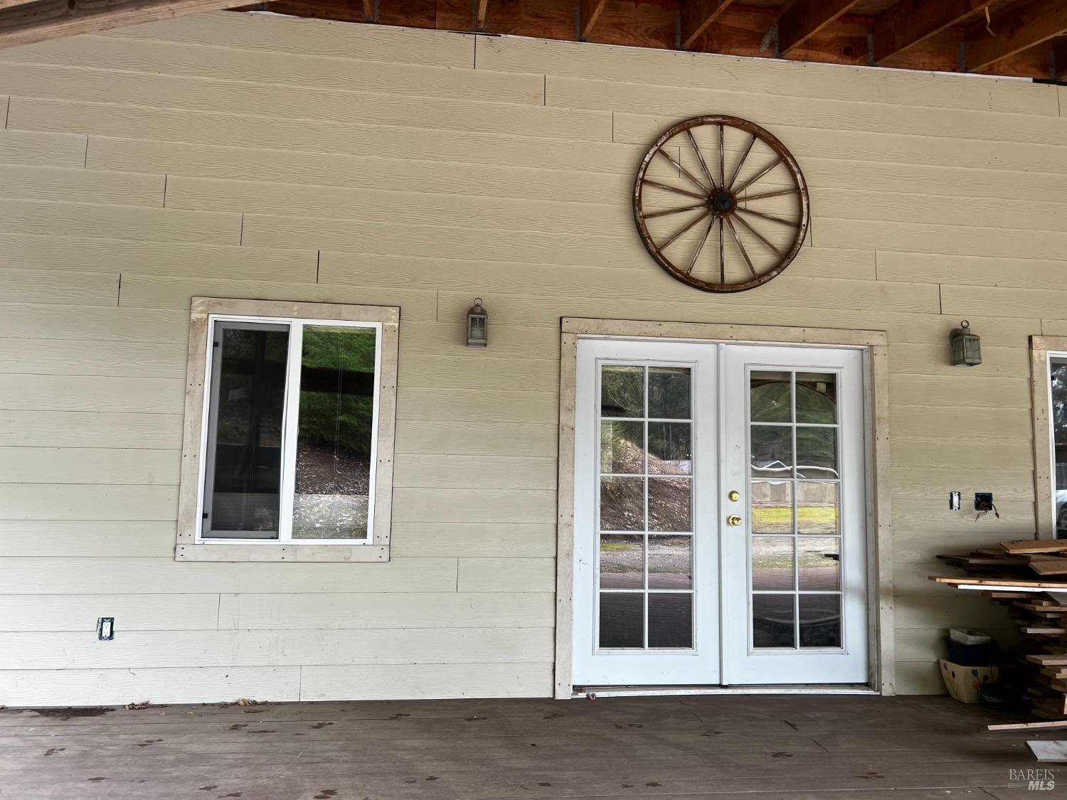 3761 East Blue Rock Road Garberville, CA 95542 - Photo 27 of 38 a front view of a building with a large window and a ceiling fan