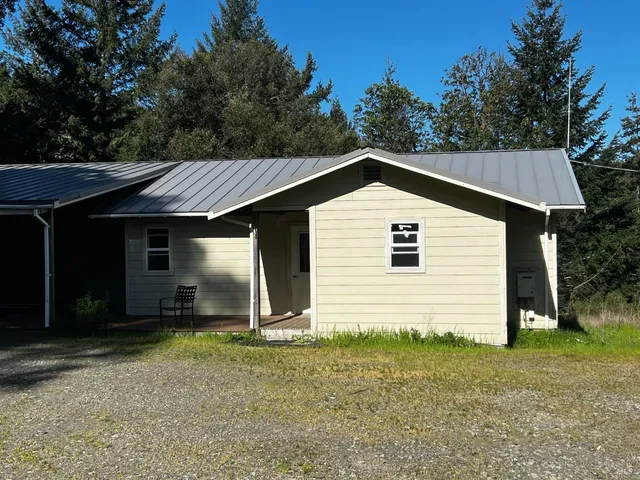a kitchen with granite countertop wooden cabinets and a stove