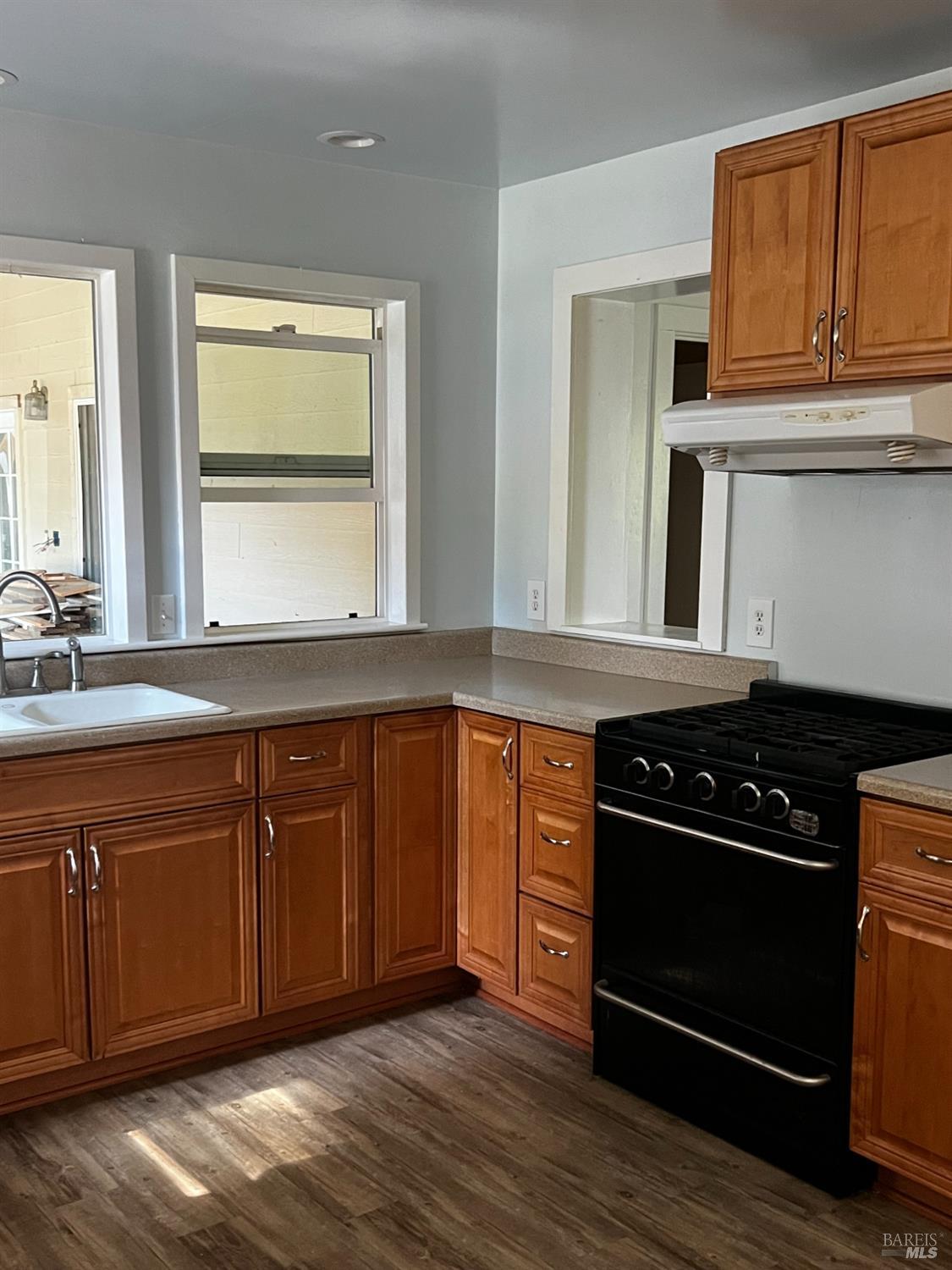 3761 East Blue Rock Road Garberville, CA 95542 - Photo 6 of 38 a kitchen with granite countertop wooden cabinets and a stove